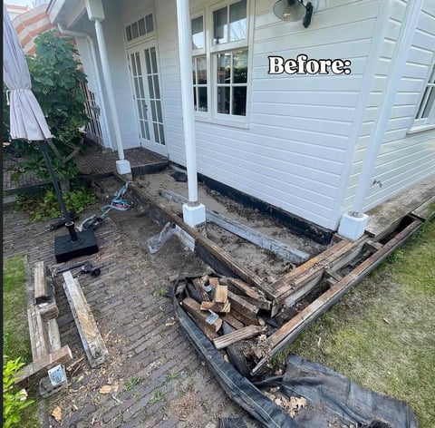 Before photo of a home foundation renovation showing deteriorated wooden structure and old framing before repairs